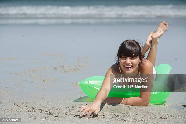 young woman with air mattress on the beach - fußsohle stock-fotos und bilder
