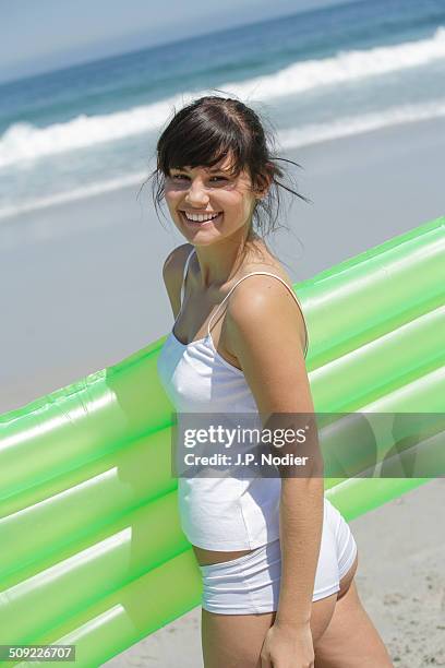 young woman with air mattress on the beach - one young woman only photos et images de collection