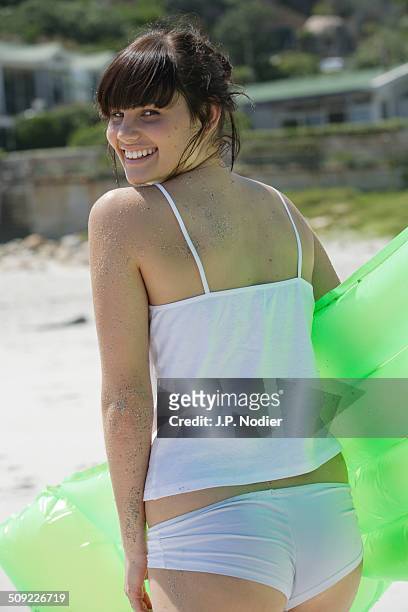young woman with air mattress on the beach - one young woman only photos et images de collection