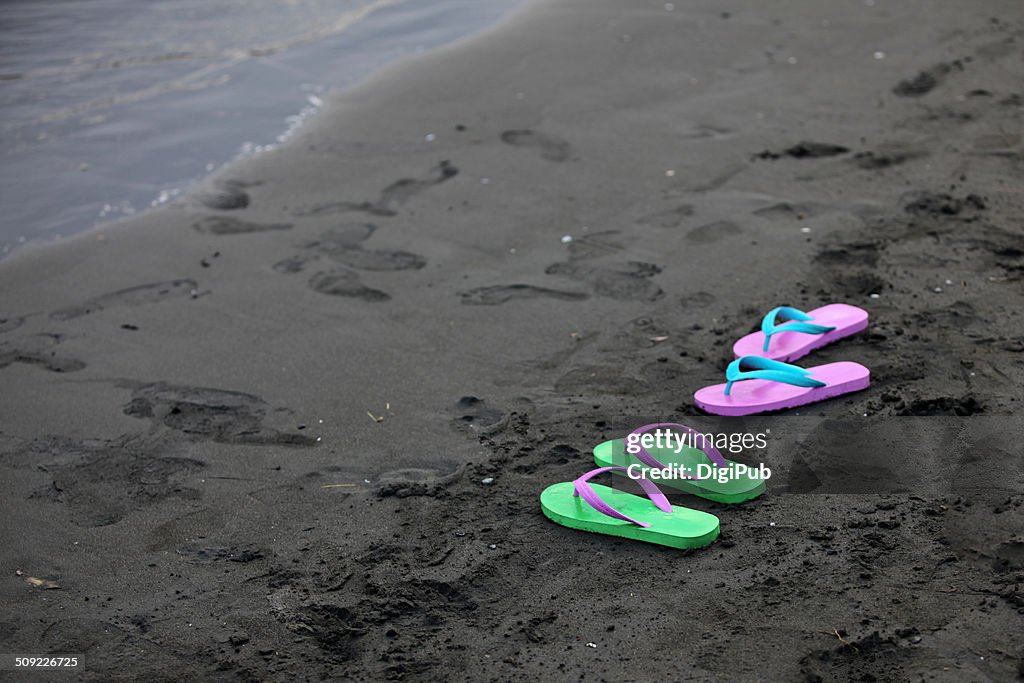 Slippers on beach sand