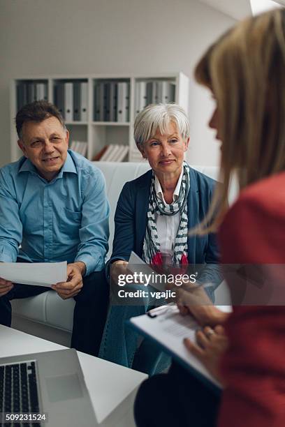 mature couple meeting with financial advisor - legal assistance stock pictures, royalty-free photos & images