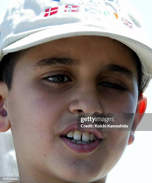 Mohamad Haytham Saleh, a 10-year-old Iraqi boy, answers reporter's questions in a parking area on the way to the hospital on June 4, 2004 in Ebina,...