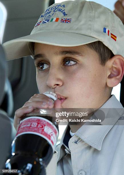 Mohamad Haytham Saleh, a 10-year-old Iraqi boy, drinks a soda in a parking area on the way to the hospital on June 4, 2004 in Ebina, Kanagawa...