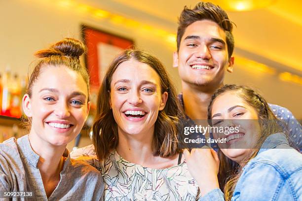 selfie self portrait of a celebrating group of young friends - aboriginal artwork stockfoto's en -beelden