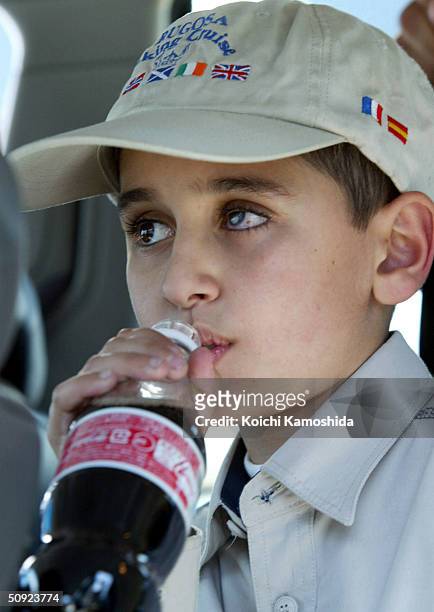 Mohamad Haytham Saleh, a 10-year-old Iraqi boy, drinks a soda in a parking area on the way to the hospital on June 4, 2004 in Ebina, Kanagawa...
