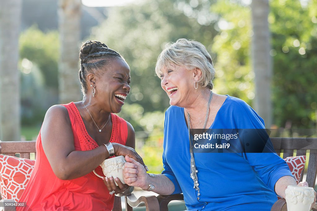 Senior women enjoying cup of coffee together, talking