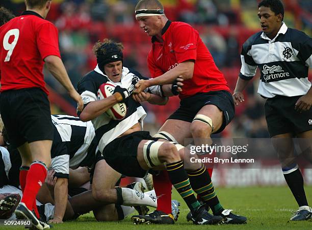 Mark Connors of the Barbarians is tackled by Brent Cockbain of Wales during the match between Wales and the Barbarians held at Ashton Gate on May 26...