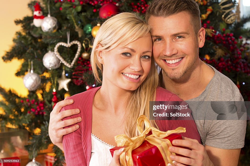 Couple Exchanging Christmas Gifts