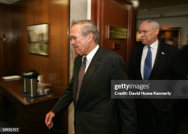 Secretary of Defense Donald Rumsfeld and Secretary of State Colin Powell enter Rumsfeld's office at the Pentagon to discuss the situation in Iraq...