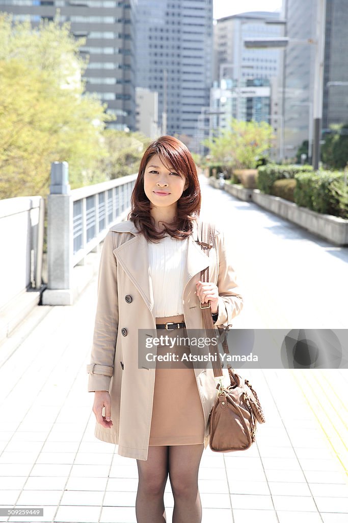 Japanese business woman standing in city location