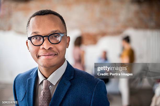 confident businessman at creative office - businesswear fotografías e imágenes de stock