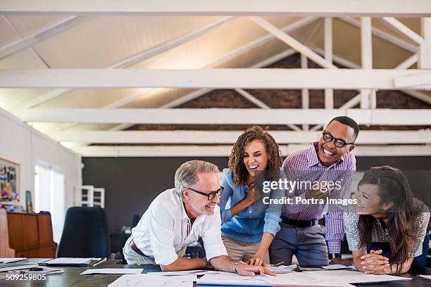 happy business people working in office - coworkers laughing stock pictures, royalty-free photos & images