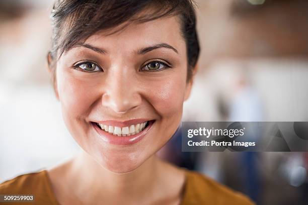 happy businesswoman in creative office - grüne augen stock-fotos und bilder