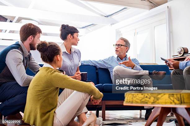 businessman people discussing in creative office - group on couch stock pictures, royalty-free photos & images