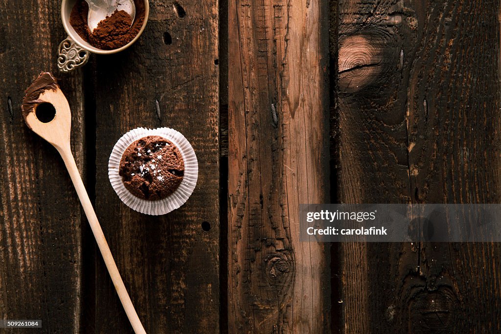 Chocolate muffin on dark wooden board