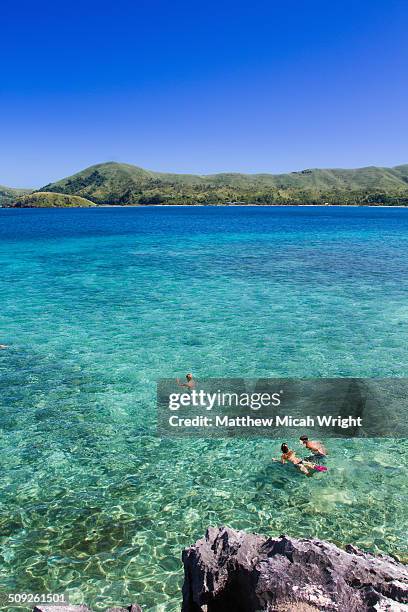 swimming in the crystal clear fiji waters - fiji island stock pictures, royalty-free photos & images