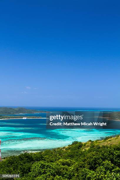 a ship docks at the blue lagoon. - yasawa island group stock pictures, royalty-free photos & images