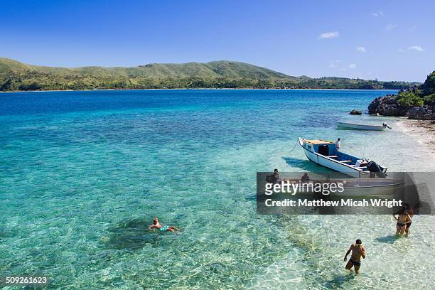 a boat takes passengers to the sawa-i-lau caves - fiji stock pictures, royalty-free photos & images