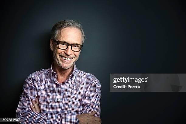 happy mature businessman standing arms crossed - man wearing plaid shirt stock pictures, royalty-free photos & images