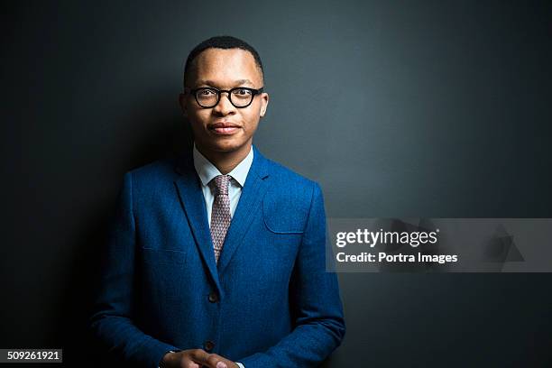 portrait of confident young businessman - blue suit stock pictures, royalty-free photos & images