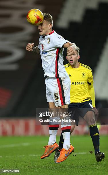 Kyle McFadzean of Milton Keynes Dons heads the ball clear during the Sky Bet Championship match between Milton Keynes Dons and Middlesbrough at...