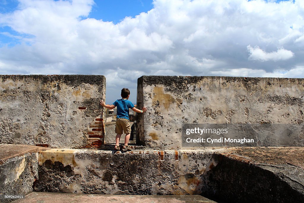 Boy Looking over Wall