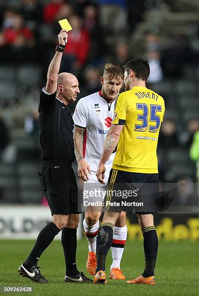 David Nugent of Middlesbrough is shown a yellow card by referee Andy Davies during the Sky Bet Championship match between Milton Keynes Dons and...