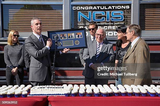 Director Andrew Traver presents executive producer Gary Glasberg with a special presentation at the cake cutting celebration for "NCIS" 300th episode...