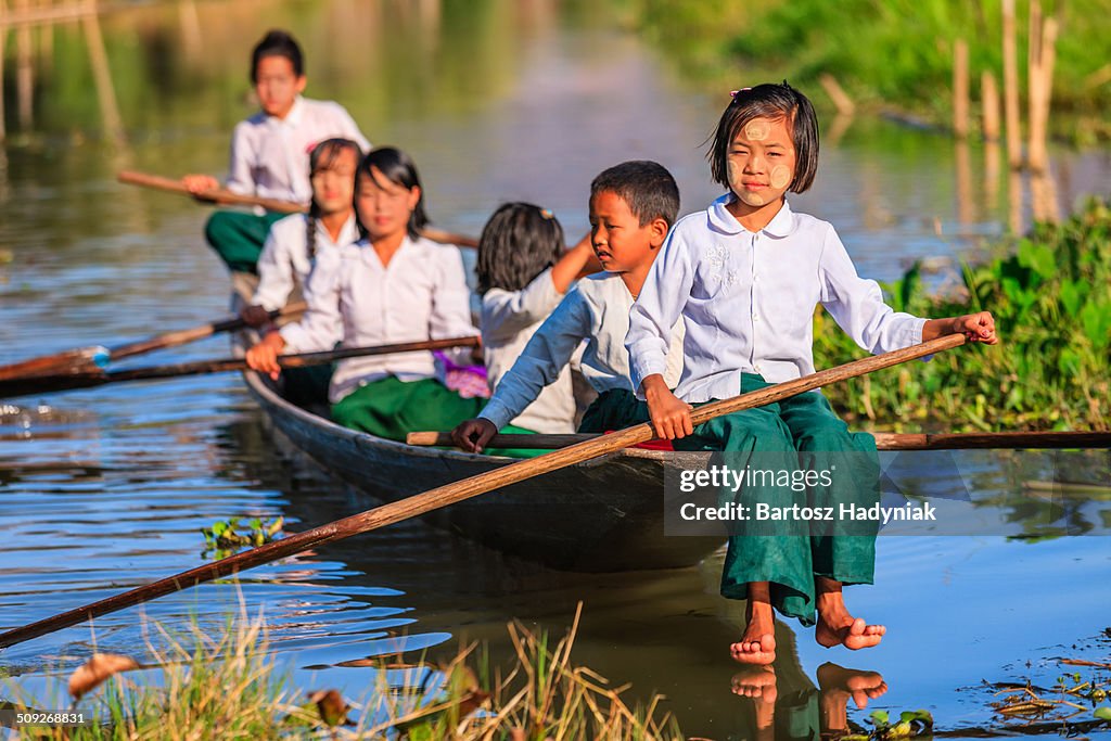 Burmese students on their way to school by boat