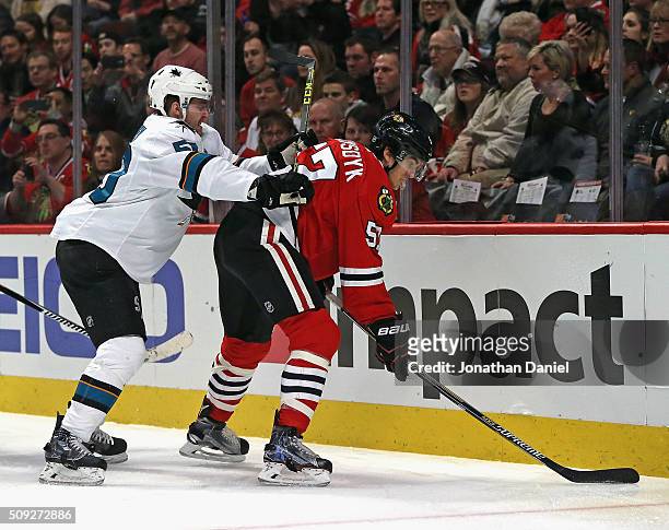 Chris Tierney of the San Jose Sharks pressures Trevor van Riemsdyk of the Chicago Blackhawks at the United Center on February 9, 2016 in Chicago,...