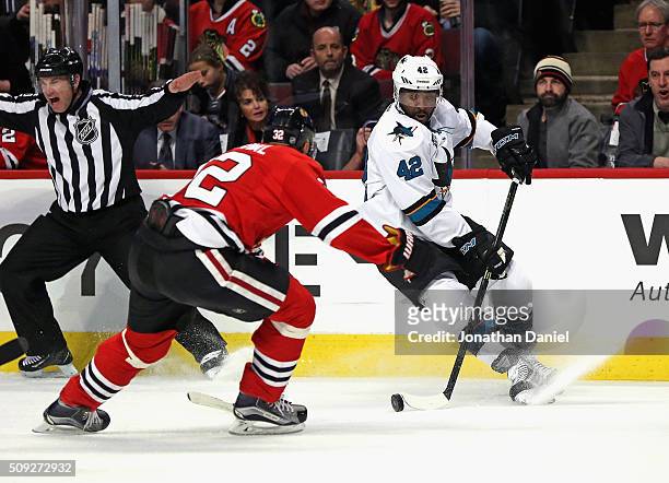 Joel Ward of the San Jose Sharks turns to avoid Michal Rozsival of the Chicago Blackhawks at the United Center on February 9, 2016 in Chicago,...