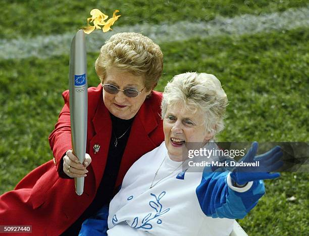 Betty Cuthbert former Olympian waves to the crowd during the torch relay at half time of the round eleven AFL match between the Hawthorn Hawks and...