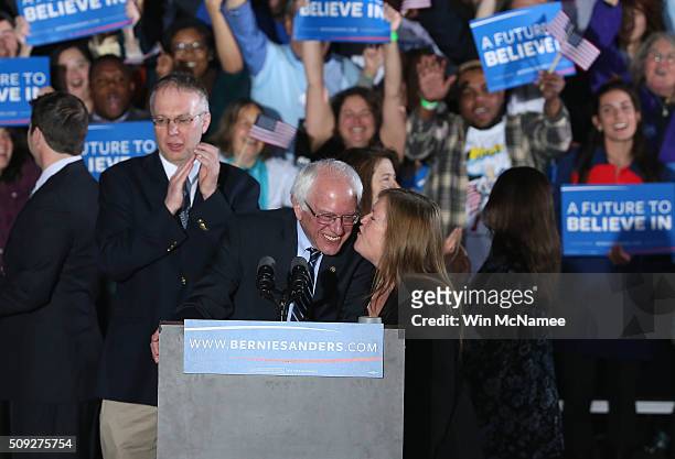 Democratic presidential candidate Bernie Sanders and his wife Jane O'Meara kiss while greeting supporters after winning the New Hampshire Democratic...