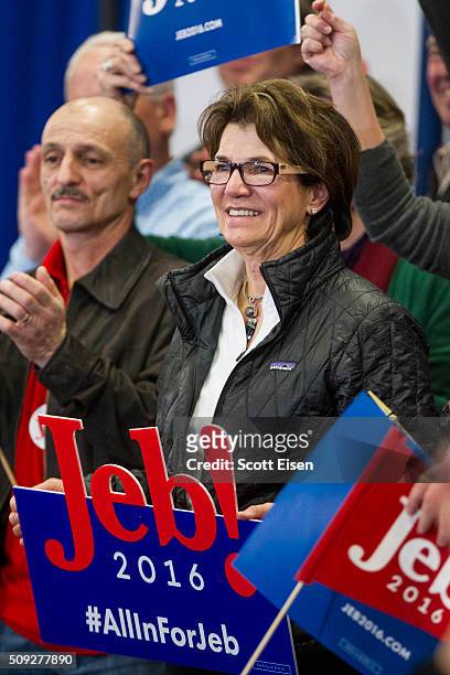 Beverly Bruce holds a Jeb sign during Republican presidential candidate Jeb Bush's election night party at Manchester Community College on February...