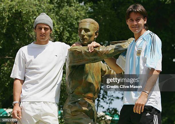 Gason Gaudio and Guillermo Coria of Argentina pose for pictures at the Jacques Brugnon statue prior to their men final match tomorrow during Day...