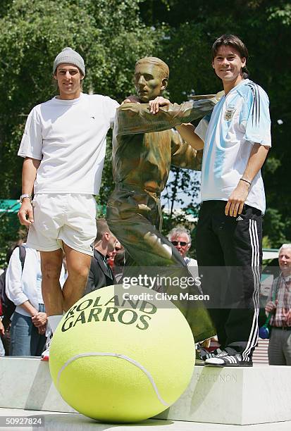Gason Gaudio stands with Guillermo Coria of Argentina at the Jacques Brugnon statue prior to their men final match tomorrow during Day Thirteen of...
