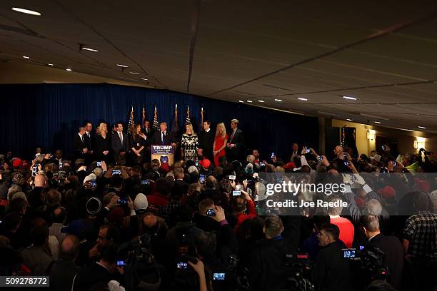 Republican presidential candidate Donald Trump speaks as his wife Melania Trump and daughter Ivanka Trump look on after Primary day at his election...