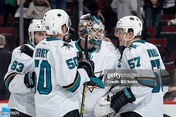 Goalie Martin Jones of the San Jose Sharks celebrates with Tommy Wingels after defeating the Chicago Blackhawks 2 to 0 during the NHL game at the...