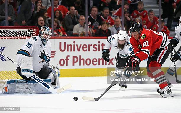 Marian Hossa of the Chicago Blackhawks tries to get off a shot against Martin Jones of the San Jose Sharks as Brent Burns defends at the United...