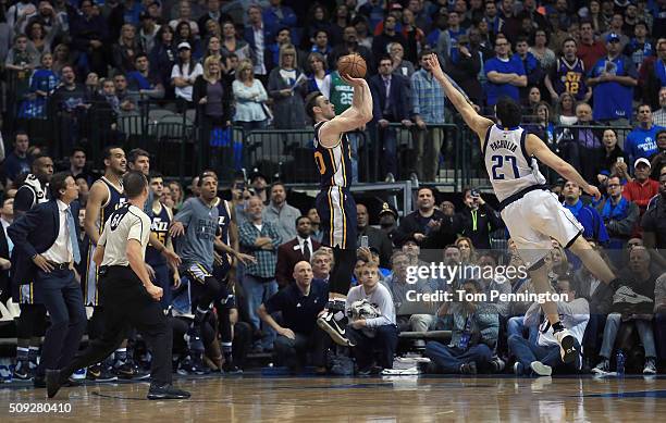 Gordon Hayward of the Utah Jazz shoots the game winning basket against Zaza Pachulia of the Dallas Mavericks in overtime at American Airlines Center...