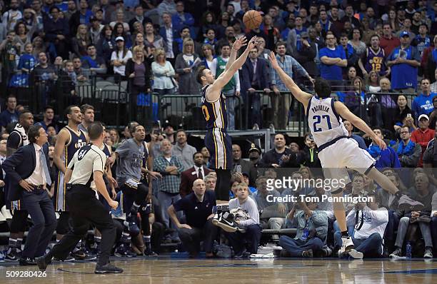 Gordon Hayward of the Utah Jazz shoots the game winning basket against Zaza Pachulia of the Dallas Mavericks in overtime at American Airlines Center...