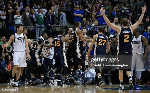 Gordon Hayward of the Utah Jazz celebrates with his team after shooting the game winning basket against Zaza Pachulia of the Dallas Mavericks in...