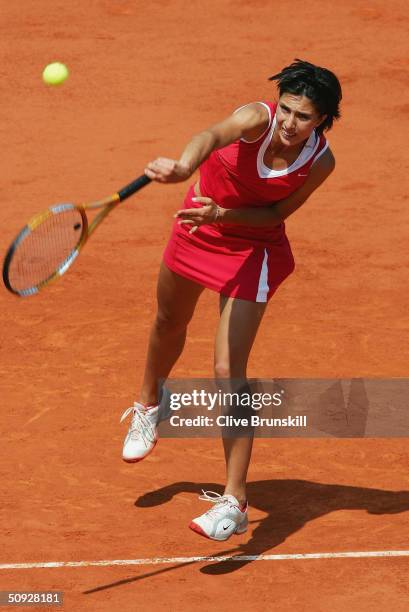 Anastasia Myskina of Russia serves in her womens final match against Elena Dementieva of Russia during Day Thirteen of the 2004 French Open Tennis...