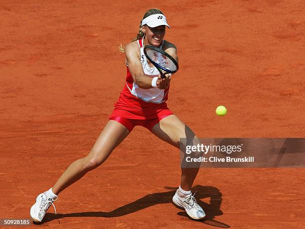Elena Dementieva of Russia returns in her womens final match against Anastasia Myskina of Russia during Day Thirteen of the 2004 French Open Tennis...
