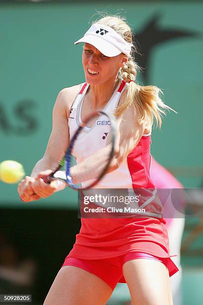 Elena Dementieva of Russia plays a return during her womens final match against Anastasia Myskina of Russia on Day Thirteen of the 2004 French Open...
