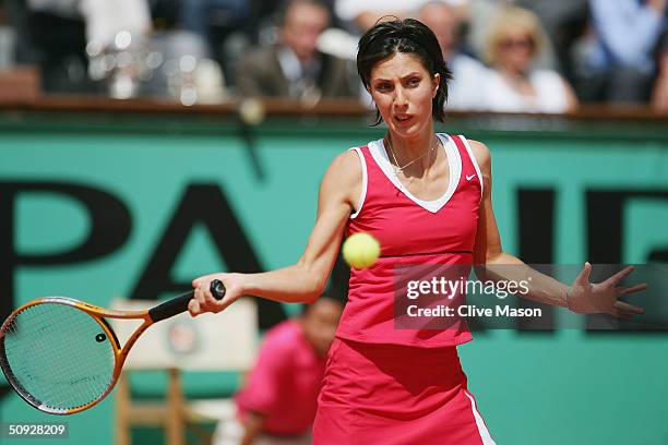 Anastasia Myskina of Russia plays a return during her womens final match against Elena Dementieva of Russia on Day Thirteen of the 2004 French Open...