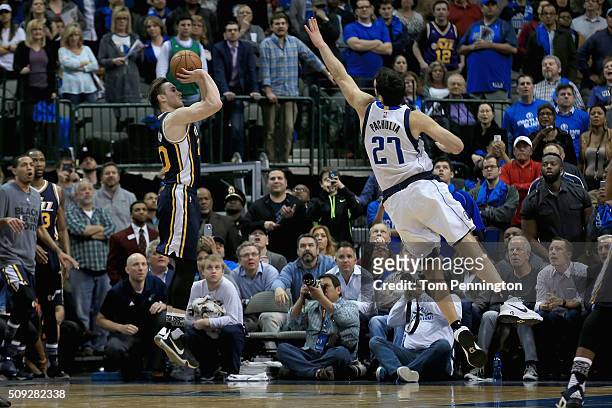 Gordon Hayward of the Utah Jazz shoots the game winning basket against Zaza Pachulia of the Dallas Mavericks in overtime at American Airlines Center...