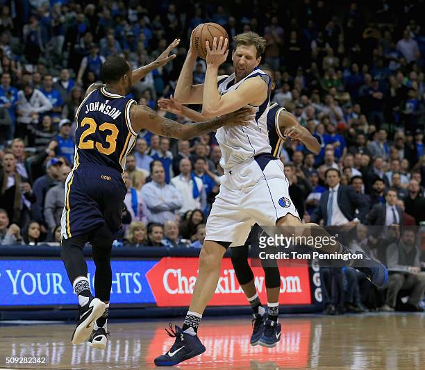 Dirk Nowitzki of the Dallas Mavericks scrambles for the ball against Chris Johnson of the Utah Jazz in overtime at American Airlines Center on...