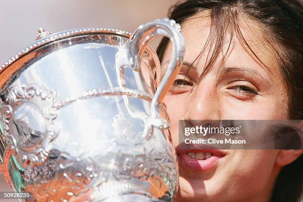 Anastasia Myskina of Russia celebrates with the trophy after winning her womens final match against Elena Dementieva of Russia during Day Thirteen of...