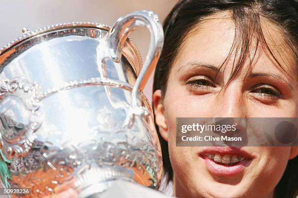 Anastasia Myskina of Russia celebrates with the trophy after winning her womens final match against Elena Dementieva of Russia during Day Thirteen of...